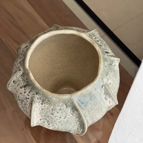 A glazed vessel with a ruffled rim